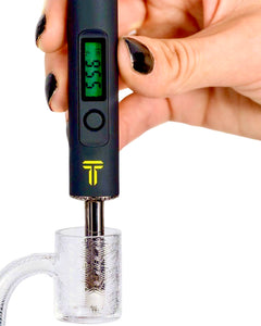 A black Terpometer measuring the temperature of a dab nail.